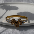 Bow charm bracelet with cubic zirconia